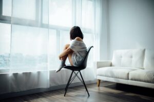 little girl huddling on chair