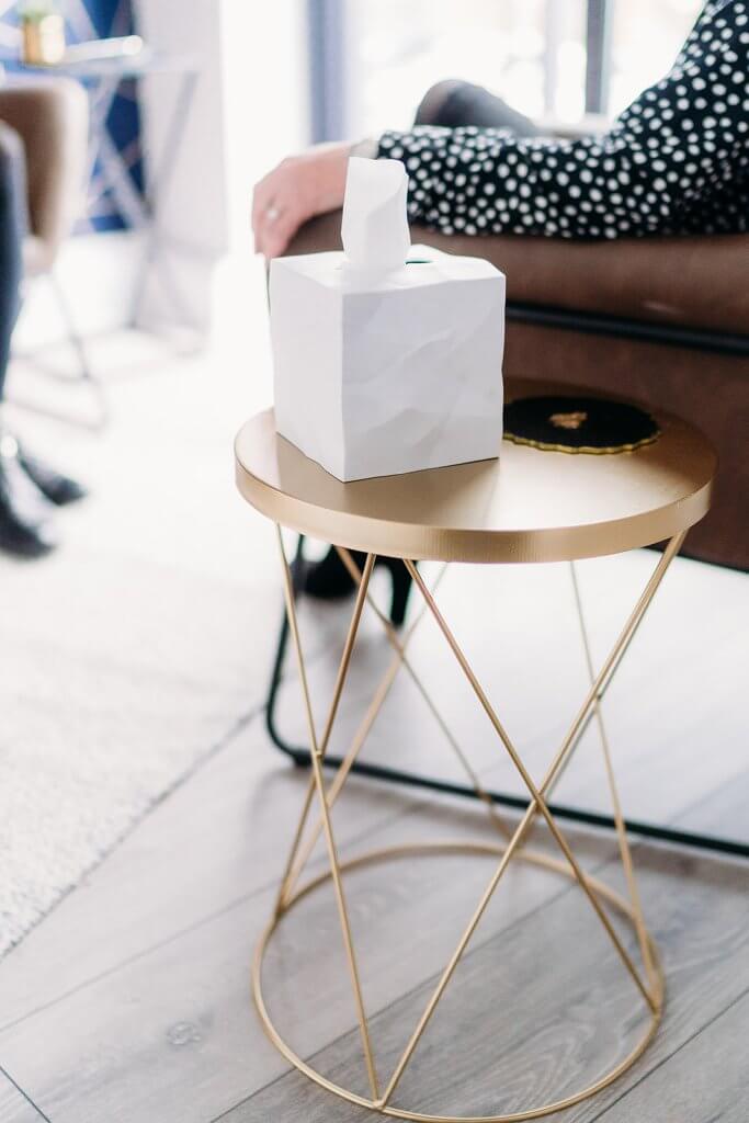 white box of tissues on gold table